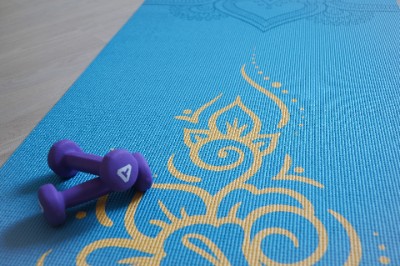 Blue yoga mat and dumbbells